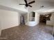Open-concept living room shows staircase to upper level and eat-in kitchen with tile floors throughout at 1015 S Val Vista Dr # 52, Mesa, AZ 85204