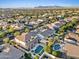 Expansive aerial view of a suburban neighborhood with pools, landscaping, and mountain views in the distance at 10331 E Starion Ave, Mesa, AZ 85212