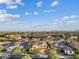 This community boasts well-maintained homes and landscapes with a mountain backdrop under a sky with scattered clouds at 10331 E Starion Ave, Mesa, AZ 85212