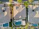 This aerial view highlights a home with a private pool and backyard oasis nestled amongst neighboring properties at 10331 E Starion Ave, Mesa, AZ 85212