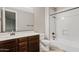 A bathroom with a stylish dark wood vanity, sleek fixtures, and a bright, clean shower tub combination at 10331 E Starion Ave, Mesa, AZ 85212