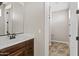 Beautiful bathroom featuring a dark vanity, stylish fixtures, and a well-lit mirror at 10331 E Starion Ave, Mesa, AZ 85212