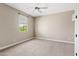 Bright bedroom featuring neutral carpet and paint, and a window offering plenty of natural light at 10331 E Starion Ave, Mesa, AZ 85212