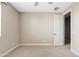 This bedroom has a ceiling fan, neutral carpet and paint, and a doorway to the rest of the home at 10331 E Starion Ave, Mesa, AZ 85212