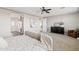 An airy bedroom features a ceiling fan, modern decor, and leads to a well-lit en suite bathroom at 10331 E Starion Ave, Mesa, AZ 85212