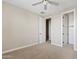 Neutral bedroom with soft carpet, ceiling fan, and easy access to closet, perfect for rest and relaxation at 10331 E Starion Ave, Mesa, AZ 85212
