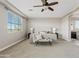 A spacious bedroom with neutral carpet, a ceiling fan, and plenty of natural light at 10331 E Starion Ave, Mesa, AZ 85212