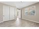 Cozy bedroom boasts tile flooring, closet with sliding doors, and a bright window offering outdoor views at 10331 E Starion Ave, Mesa, AZ 85212
