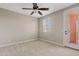 Cozy bedroom featuring a ceiling fan, natural light from window, and convenient access to a private balcony at 10331 E Starion Ave, Mesa, AZ 85212