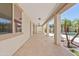 Extended covered patio with tiled floors, providing a comfortable outdoor living area with views of the landscaped backyard at 10331 E Starion Ave, Mesa, AZ 85212