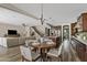 Elegant dining area with seating for four, flowing into the living room and a kitchen with stainless steel appliances at 10331 E Starion Ave, Mesa, AZ 85212