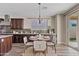 Charming dining area features seating for four, stylish lighting, and access to the patio, adjacent to the modern kitchen at 10331 E Starion Ave, Mesa, AZ 85212
