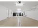 Spacious, bright garage with storage cabinets and shelving, ideal for organization and parking vehicles at 10331 E Starion Ave, Mesa, AZ 85212