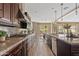Modern kitchen with granite countertops, stainless steel appliances, gas cooktop, and seamless flow to the dining area at 10331 E Starion Ave, Mesa, AZ 85212