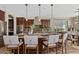 Kitchen island with bar stool seating overlooks the dining area and features granite countertops and stainless appliances at 10331 E Starion Ave, Mesa, AZ 85212