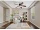 Inviting living room showcasing a tray ceiling, fan, stylish rug, and cozy armchair with natural light at 10331 E Starion Ave, Mesa, AZ 85212
