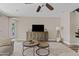 Relaxing living room featuring stylish coffee tables, an entertainment center, and a view of the outdoors at 10331 E Starion Ave, Mesa, AZ 85212