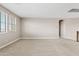 Bright, open living space features neutral carpet and paint, with abundant natural light from large windows at 10331 E Starion Ave, Mesa, AZ 85212