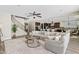Spacious open-concept living room leading to a modern kitchen, with a staircase and comfortable sectional sofa at 10331 E Starion Ave, Mesa, AZ 85212