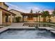 Backyard pool area featuring a built in outdoor kitchen with string lights and a stone fireplace at 10331 E Starion Ave, Mesa, AZ 85212