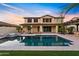 Backyard view of the pool, spa, outdoor kitchen, and a beautiful two-story home at 10331 E Starion Ave, Mesa, AZ 85212