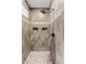 Modern walk-in shower with neutral tile, built-in niches, and a rainfall shower head at 10331 E Starion Ave, Mesa, AZ 85212