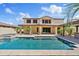 Gorgeous backyard with a large rectangular pool, spa, lush landscaping, and covered patio, ideal for outdoor living at 10331 E Starion Ave, Mesa, AZ 85212