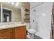 Bathroom featuring a wood vanity, stone countertop, and shower with a glass door at 11361 E Escondido Ave, Mesa, AZ 85208