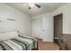 Cozy bedroom with wood look floors, a fan, and large closet, perfect for comfort and storage at 11361 E Escondido Ave, Mesa, AZ 85208