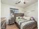 Bedroom with wood-look flooring, ceiling fan and a large window for natural light at 11361 E Escondido Ave, Mesa, AZ 85208