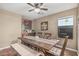 Charming dining room featuring a wooden table, upholstered chairs, and a bench for seating at 11361 E Escondido Ave, Mesa, AZ 85208