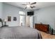 Relaxing primary bedroom with hardwood floors, ceiling fan, and access to the en-suite bathroom at 11361 E Escondido Ave, Mesa, AZ 85208