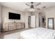 Bright bedroom featuring a ceiling fan, neutral walls, and a rustic dresser for ample storage at 11658 E Chevelon Trl, Gold Canyon, AZ 85118