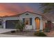 Charming single-story home featuring desert landscaping and a cozy front porch with stone pathway at 11658 E Chevelon Trl, Gold Canyon, AZ 85118