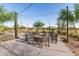 Outdoor fire pit area with chairs and string lights, creating a cozy and inviting gathering space at 11658 E Chevelon Trl, Gold Canyon, AZ 85118