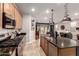 Well-equipped kitchen featuring an island with a sink, stainless steel appliances and dark countertops at 11658 E Chevelon Trl, Gold Canyon, AZ 85118