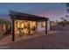Inviting covered patio featuring brick pavers, stylish furniture, and direct access to the home's interior at 11658 E Chevelon Trl, Gold Canyon, AZ 85118