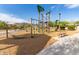 Community playground featuring climbing structures and swings, set on a mulch surface at 11658 E Chevelon Trl, Gold Canyon, AZ 85118