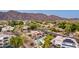 A grand estate nestled in a scenic setting, complete with a private pool, lush landscaping, and views of the mountains at 12015 S Tuzigoot Dr, Phoenix, AZ 85044