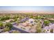 Beautiful aerial view of a well-maintained home featuring solar panels and a sparkling backyard pool at 12015 S Tuzigoot Dr, Phoenix, AZ 85044