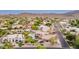 Expansive aerial view showcases a desert home neighborhood with mature trees and mountain views at 12015 S Tuzigoot Dr, Phoenix, AZ 85044