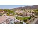 Gorgeous residence with a sparkling pool, lush green lawn, and views of the majestic mountains in the background at 12015 S Tuzigoot Dr, Phoenix, AZ 85044