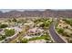 Aerial view features a beautiful desert neighborhood with mature landscaping and mountain backdrop at 12015 S Tuzigoot Dr, Phoenix, AZ 85044