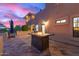 Backyard patio area featuring a fire table and views of the sunset sky at 12015 S Tuzigoot Dr, Phoenix, AZ 85044
