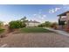 Expansive backyard space with gravel area and lush green lawn providing privacy and room for recreation at 12015 S Tuzigoot Dr, Phoenix, AZ 85044