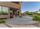 Exterior shot of a home, highlighting the landscaped backyard and a spacious patio with stairs at 12015 S Tuzigoot Dr, Phoenix, AZ 85044