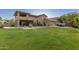Sprawling backyard featuring lush lawn, mature trees, and a covered patio, perfect for outdoor entertaining and relaxation at 12015 S Tuzigoot Dr, Phoenix, AZ 85044