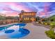 Backyard pool and patio area with mountain views at sunset at 12015 S Tuzigoot Dr, Phoenix, AZ 85044
