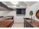 Finished basement bar with a sink, storage, wine rack, and beverage-themed decorations at 12015 S Tuzigoot Dr, Phoenix, AZ 85044