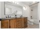 Elegant bathroom with a double sink vanity, a large mirror, decorative plants, and a separate tub/shower area at 12015 S Tuzigoot Dr, Phoenix, AZ 85044